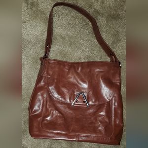 Victor bag shined brown leather feel, very nice. Aprox 12 x 13
